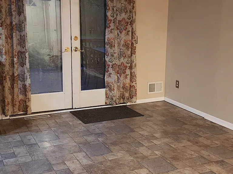 Dining Area. Laminate flooring throughout here and kitchen. French doors lead to the deck