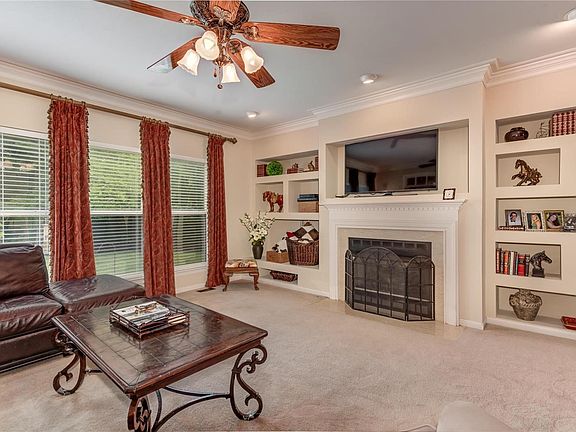 The great room also has triple crown molding, gas fireplace and a wall of built-ins