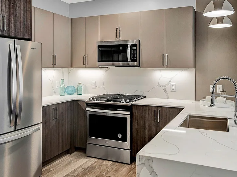 Gourmet Kitchen with SS Appliances, Waterfall Counters & Breakfast Bar