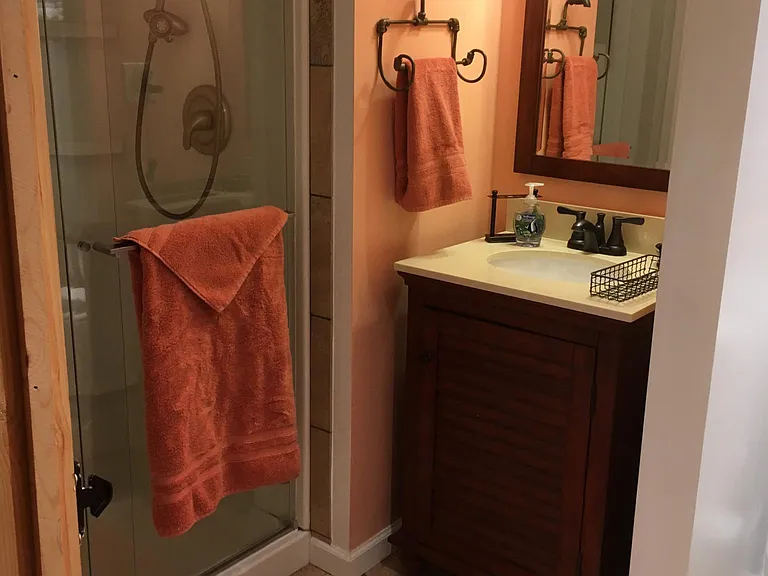 Bathroom with shower, sink commode