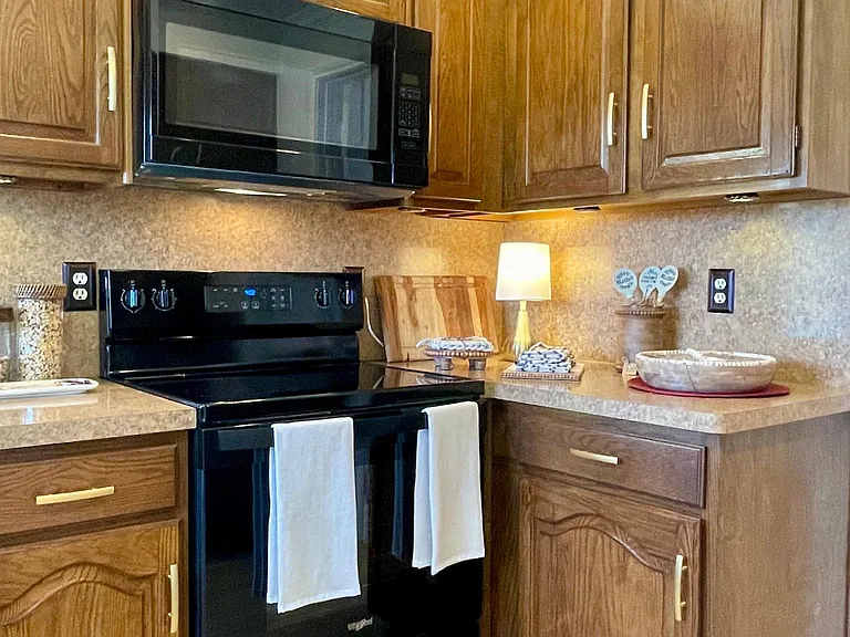 Kitchen facing Great Room Fireplace area other side of wall
NEW STOVE/MICROWAVE/DISHWASHER