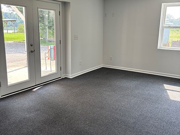 A large bedroom with room for beds and desks to work with a view