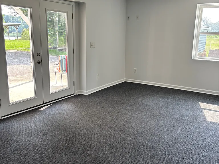 A large bedroom with room for beds and desks to work with a view