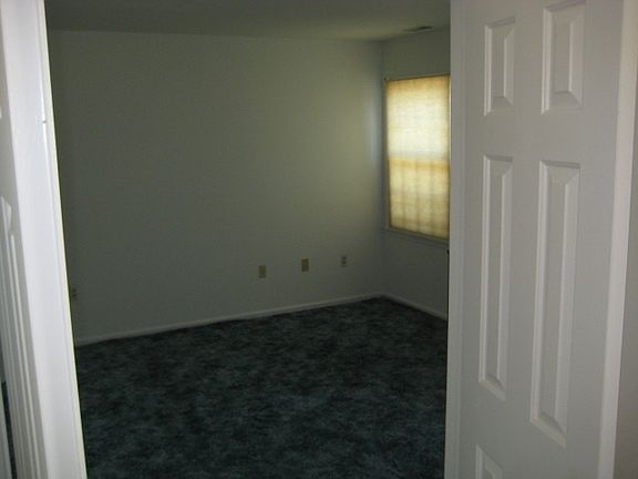Downstairs bedroom. Windows face the parking spots.