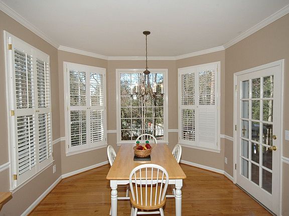 Dining nook overlooks wooded back yard.