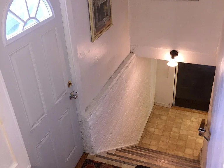 Side entry door off of driveway and stairs leading down to bathroom and bonus room