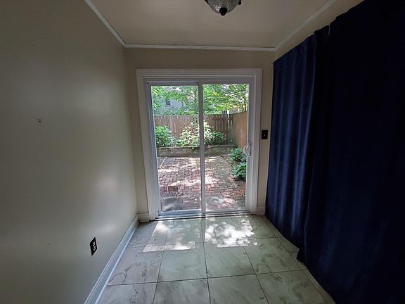 Eat-in kitchen leading to garden area. Laundry and half-bath on right