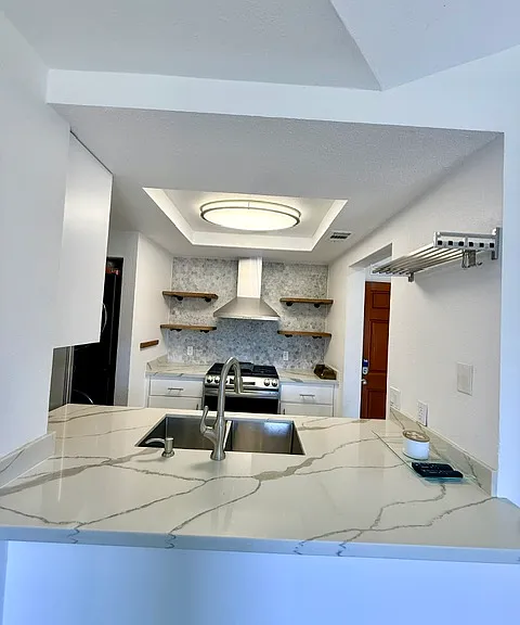 Kitchen has plenty of storage and open shelving