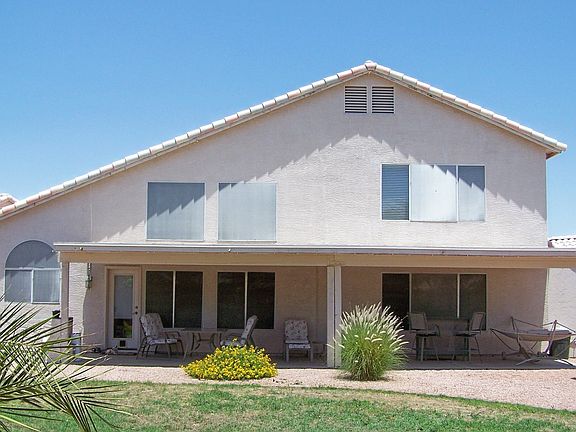 VIew of the back of the house and fully extended covered patio.