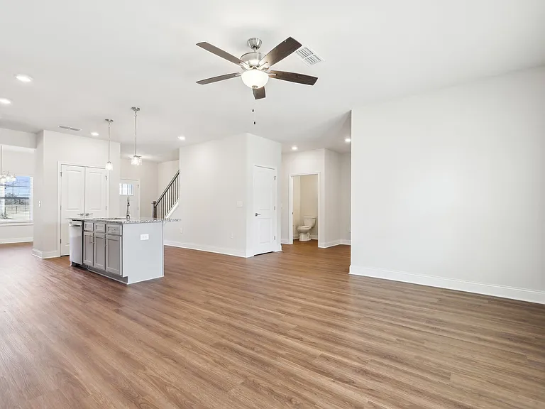 Open kitchen featuring a refrigerator, sink, and ceiling fan.