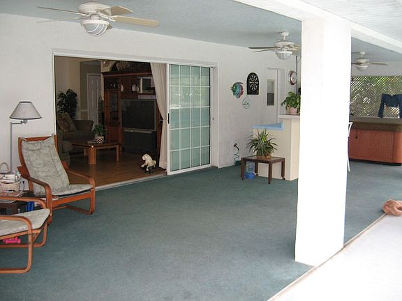 Covered porch by pool with wet bar, 3 ceiling fans and 6 person jacuzzi