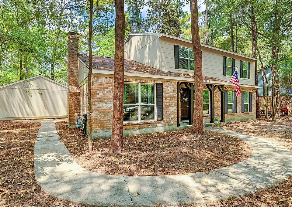 Welcome to 11819 S Red Cedar Circle . . . Charming little bridge from the roadway leads you to the front entrance; garage access is on the left corner