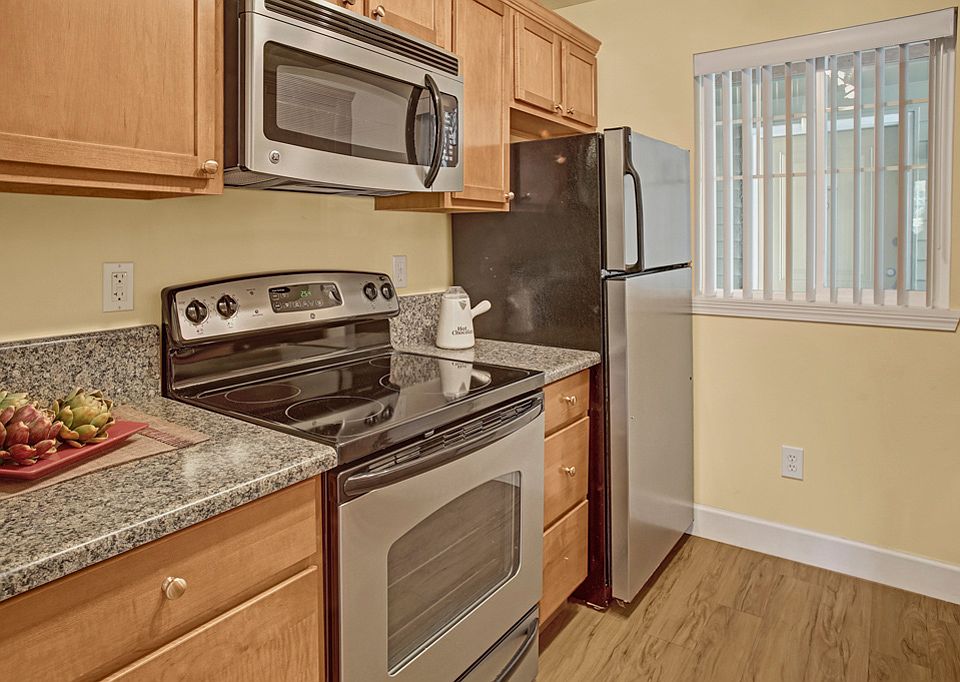 Kitchen with stainless steel oven, stove, refrigerator and microwave
