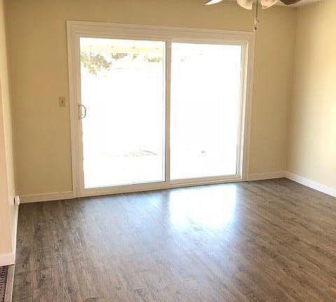 Dining area with new flooring looking out to yard