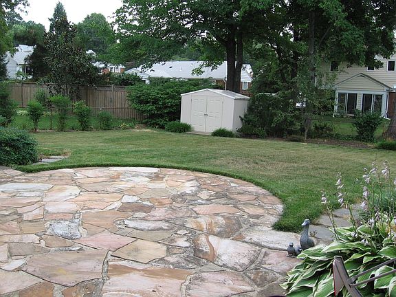 Flagstone patio opens to level backyard