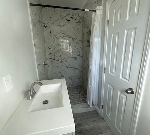 This sleek, fully remodeled bathroom offers a modern and stylish retreat. Featuring contemporary fixtures, a beautiful vanity with ample storage, and a walk-in shower, it's designed for both comfort and convenience.