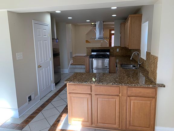 Kitchen with stainless appliances, half bath access
