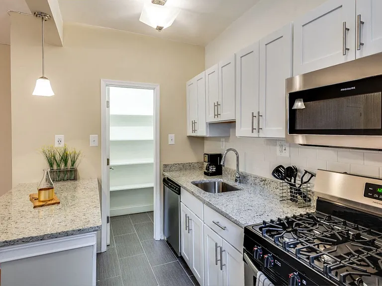 Renovated kitchen with stainless steel appliances and granite countertops