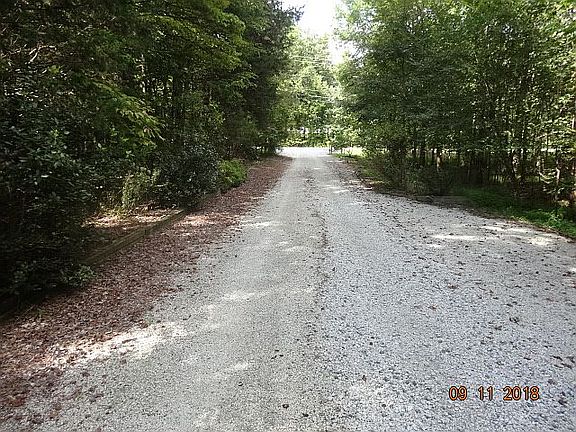 Double-wide driveway area, 100 ft, 3 parking spaces, commercial or industrial equipment.