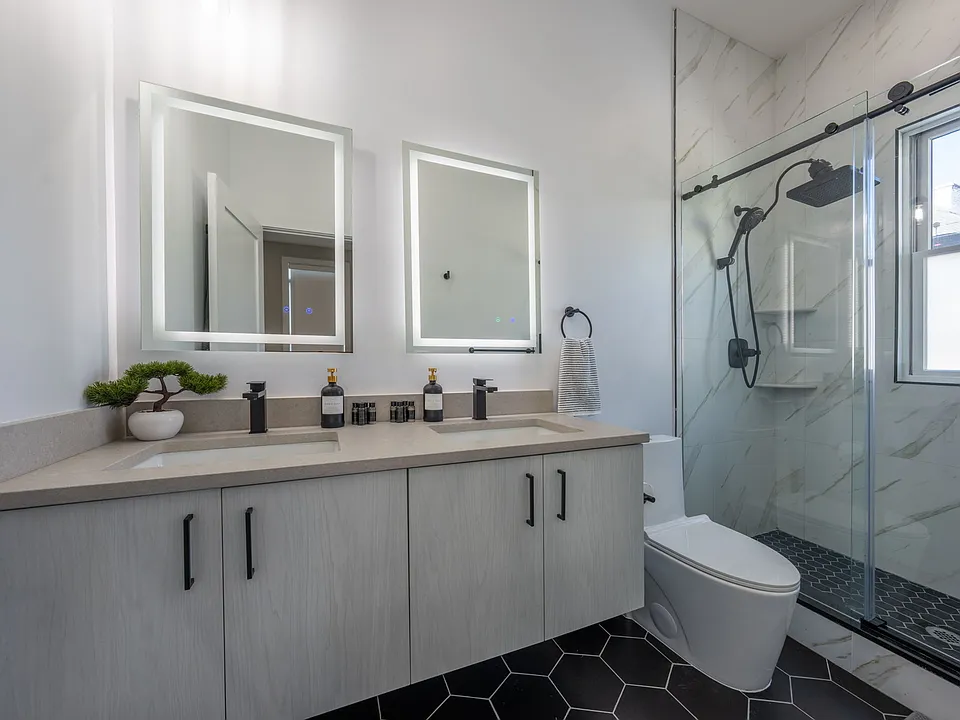 Master En-suite Bathroom completed with double vanity, walk-in shower, and 13" filtered rainfall shower head