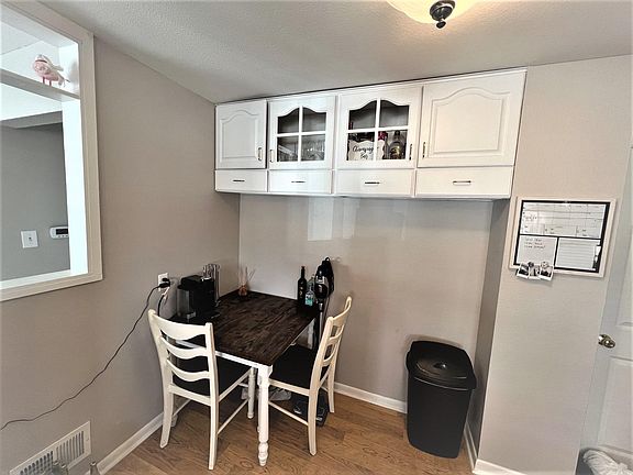 Eating space in kitchen; half wall to the living room.