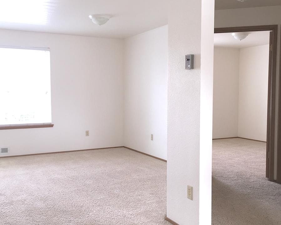 Right side of living room and looking down hall to bedroom.