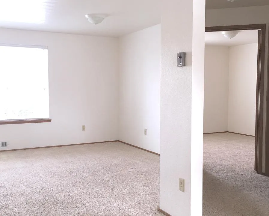 Right side of living room and looking down hall to bedroom.