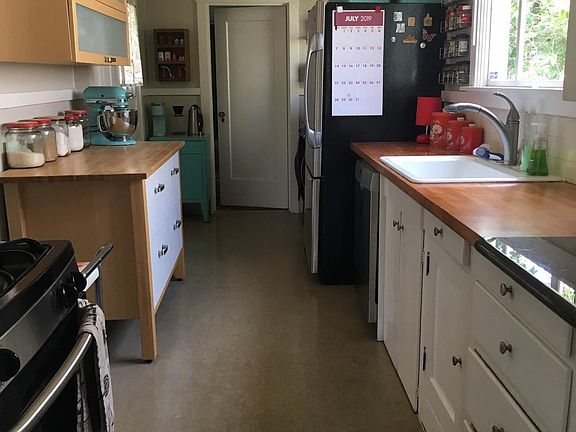 Bright, spacious kitchen with stainless steel appliances.