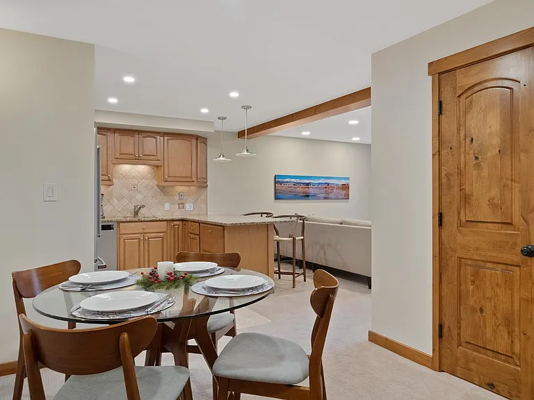 Entry flows into dedicated dining into the kitchen with bar seating