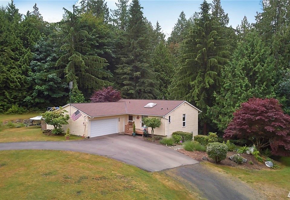 Front view of home.  2 Car garage, RV parking where boat currently is sitting.