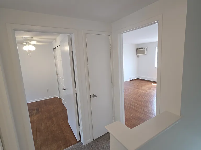 Second-level landing connecting both bedrooms and the full bathroom.