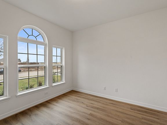 The home office features beautiful floors, large windows that give a fresh feel, this space promotes
