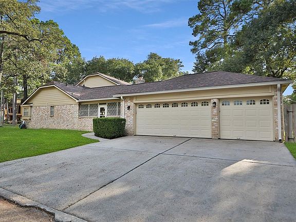 GARAGE - Three-car garage with wide driveway. Easy to share the garage and get in & out without shuffling cars. The gate on the right side of the garage is a double-wide gate and can accommodate storing a trailer behind the fence.