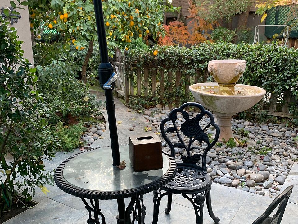 This is a view of the backyard and your private space for sitting outside. Obviously this was taken in the winter. The fountain and deep toned charms on the Property add a calming ambience. All chairs are covered with fitted cushions in the summer