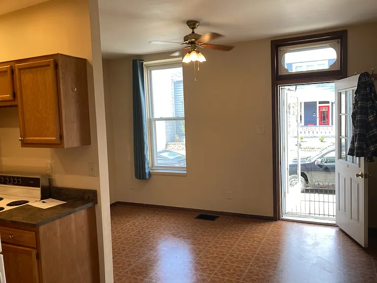 standing in dining area looking at entry door.