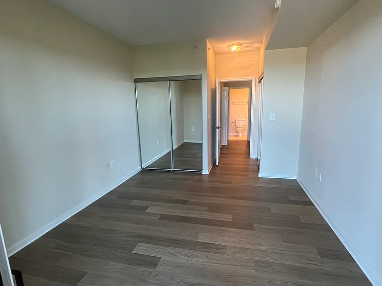 Bedroom #2 showing second reach-in closet and bathroom #2 across the hall