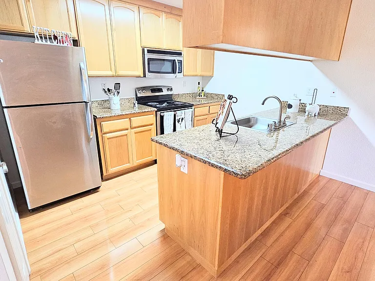 Unit 40 kitchen, you may want to get bar stools for the right side. Granite counters, stainless steel appliances, plenty of storage cabinets!