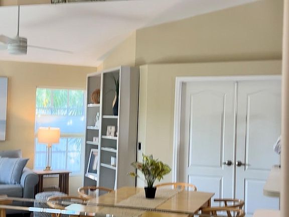 Dining area and Livingroom reflection in the mirrors. The two double doors goes into separate office/den with sleeper sofa, desk, and storage cabinets.