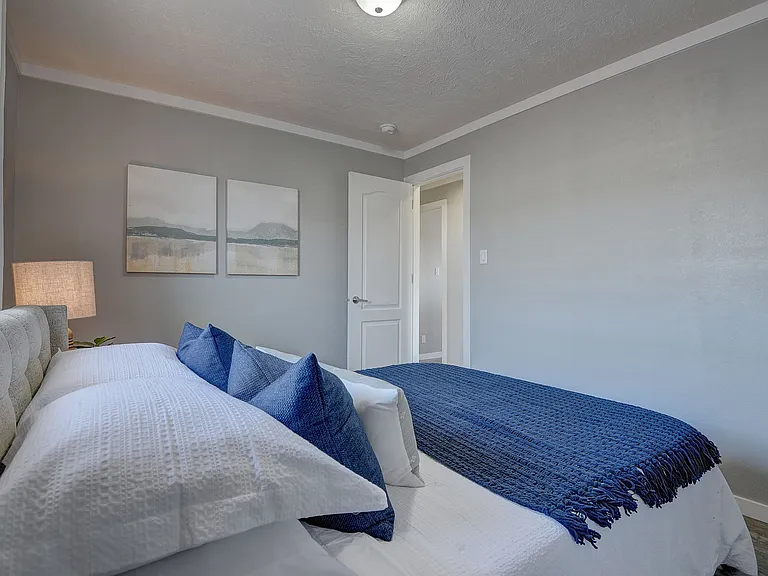 Cozy, well-appointed bedroom featuring soft natural light and clean, modern finishes_perfect for guests or everyday comfort.
