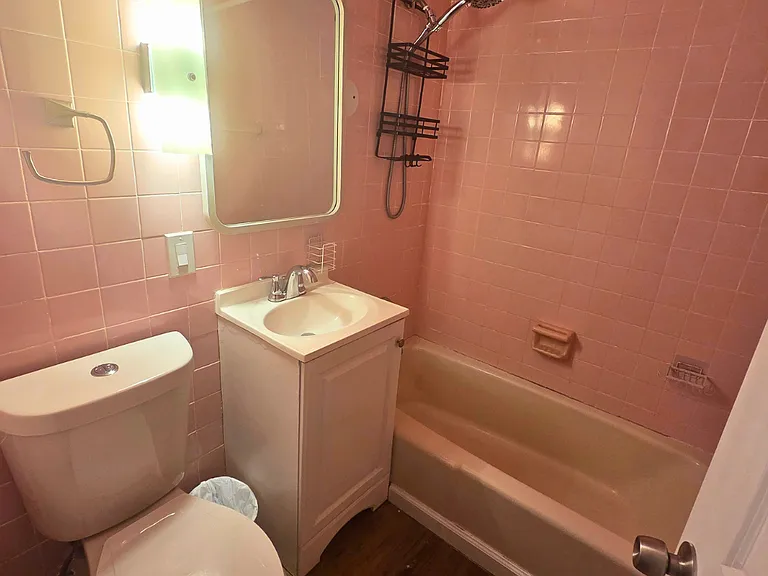 Fully equipped bathroom with a shower, towels, mirror and essentials.
