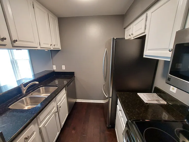 Efficient kitchen, ready for you to create your meal and have friends over! Note the stainless undermount sink and stylish microwave over the rantge.