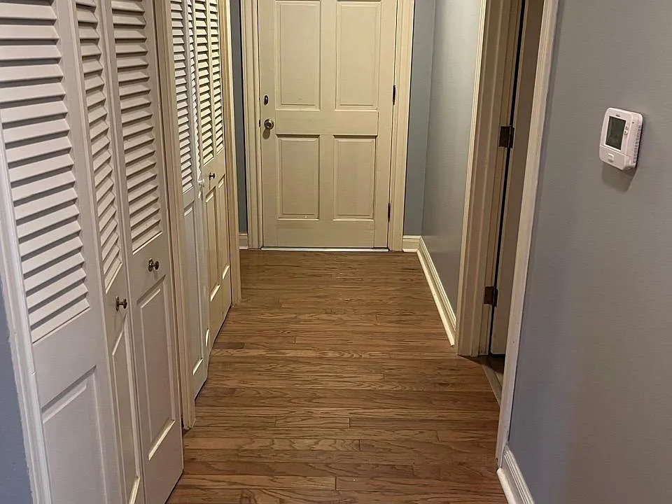 Hallway to bedrooms with large linen closet/storage shelves