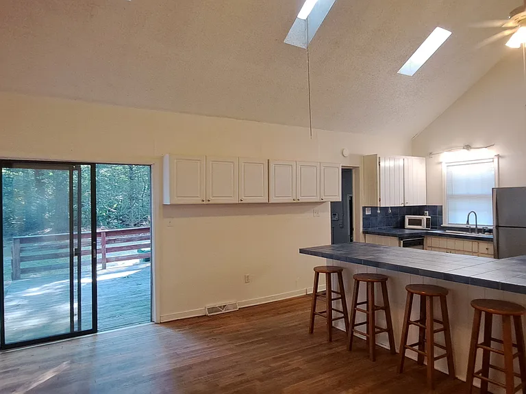 Kitchen, dining area, and back deck doorway.