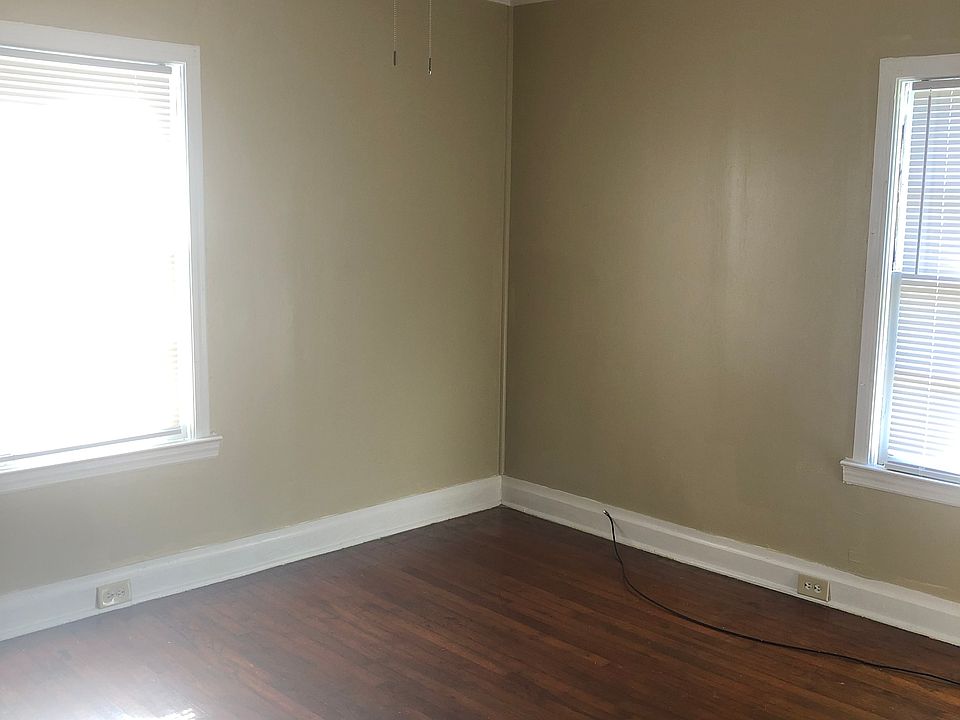 1st bedroom with freshly painted walls, new ceiling fan and polished floor.