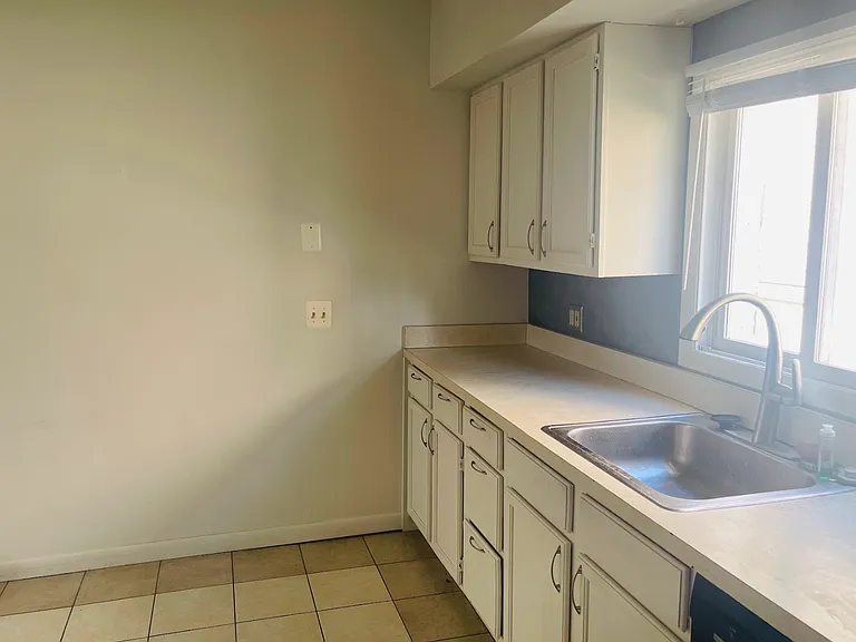 View from the entry to the laundry room which is off the kitchen. Room for a little 2-seat table. The over-sink window looks out to the driveway