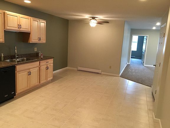 This is the kitchen showing the eating area at the far end and the entrance into the living room from the kitchen. The door on the right is the entrance into the apt.