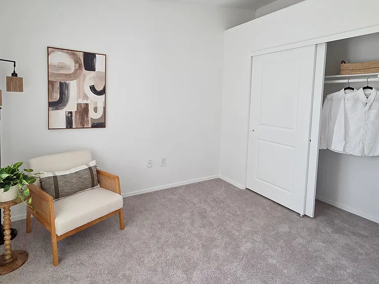 Designed with comfort in mind, this spacious bedroom offers abundant storage, natural light, and a clean, modern aesthetic that feels like home.