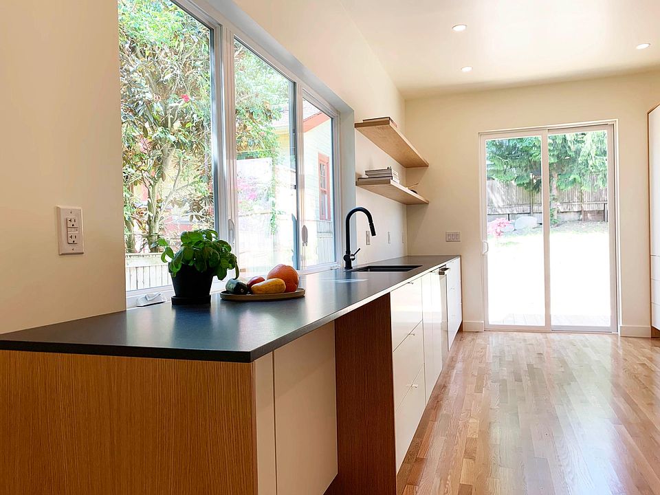 Kitchen: honed black granite counter-tops & white oak panels