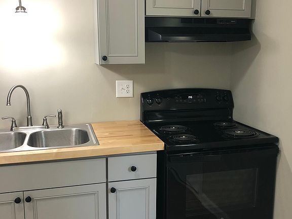 Stove, sink, cabinets and butcher block tops