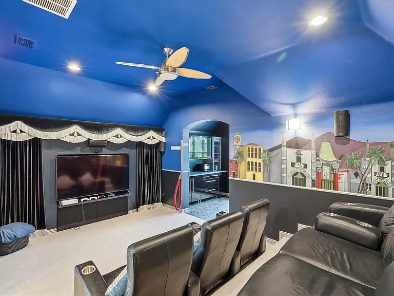 Media room complete with equipment and surround sound.